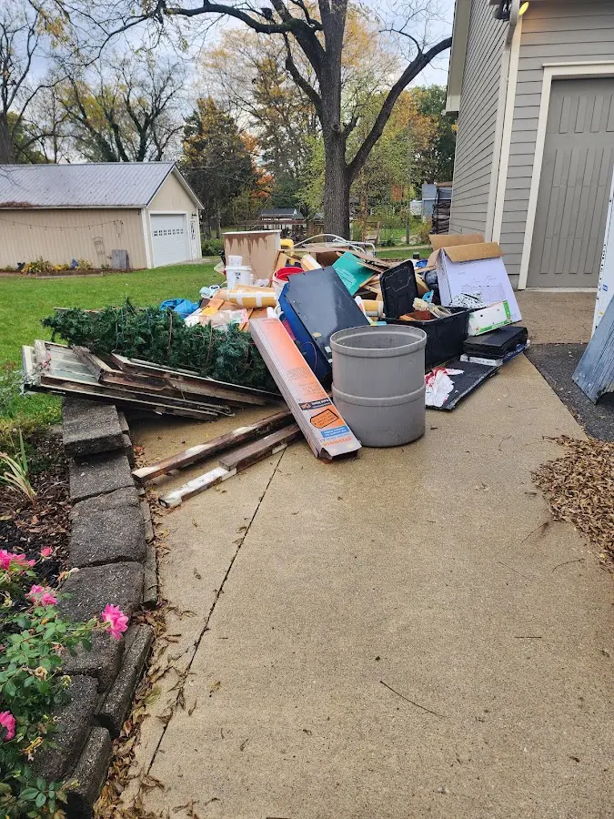 Dumpster being loaded with debris for 12 Yard Dumpster Rental in Lodi